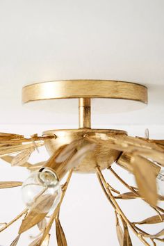 a gold chandelier hanging from the ceiling