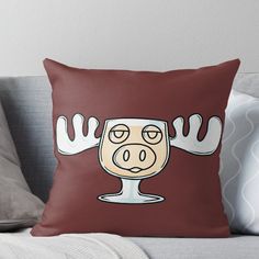 a brown throw pillow with an image of a cow's head and hands on it