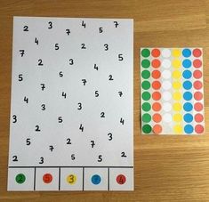 a wooden table topped with lots of different colored dots and numbers on it's side