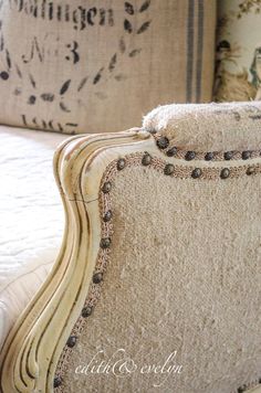 a close up of an old fashioned chair with buttons on it's armrests