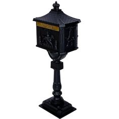 a black mailbox sitting on top of a metal post with a gold and black design