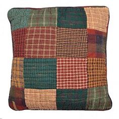 a multicolored patchwork pillow on a white background