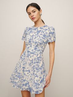 Who, me. Shop the Lula Dress from Reformation, is a mini length dress with a high neckline, short sleeves, and ruching at the bodice. Blue Floral Print Dress, Time Clothes, Reformation Dress, Swimwear Dress, Vintage Inspired Dresses, Reformation Dresses, Blue Floral Print, Georgette Fabric, Slim Fit Shorts