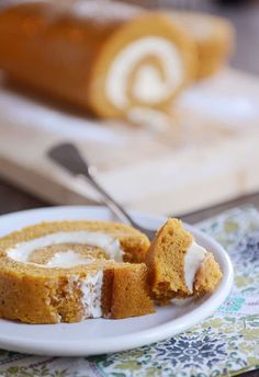 a piece of cinnamon roll sitting on top of a white plate