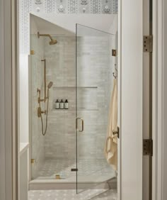 a walk in shower sitting inside of a bathroom