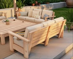 a wooden table sitting on top of a patio next to couches and tables with pillows