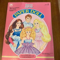 the barbie paper doll book is sitting on a table