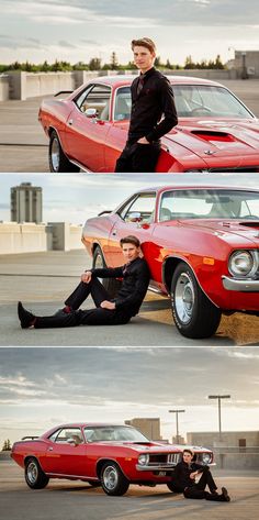 two men sitting on the ground next to an old red car and another man standing in front of it