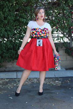 a woman in a red skirt and white shirt is posing for the camera with her hand on her hip