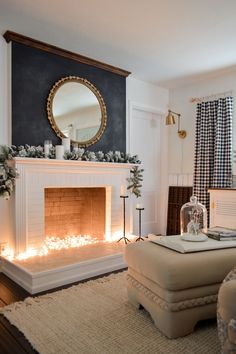 a living room filled with furniture and a fire place in front of a mirror on the wall