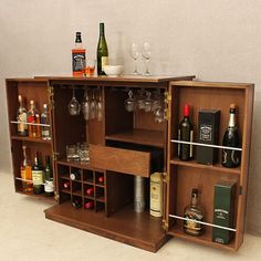 a wooden cabinet filled with liquor bottles and glasses