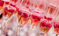 a man wearing a suit and tie next to glasses filled with champagne