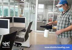 a man wearing a face mask while standing in an office