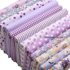 a bunch of different colored fabrics stacked on top of each other with flowers and polka dots