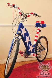 a bicycle decorated with an american flag is parked in front of a wall and red, white, and blue rug