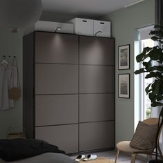 an open closet with clothes and shoes on the floor next to a bed in a room