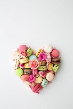 a heart made out of macaroons and roses