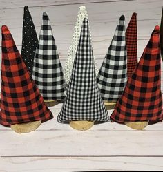 four black and white checkered cones are lined up in a row on top of each other