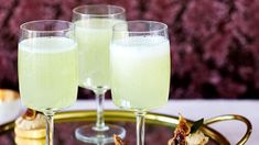 two glasses of champagne sitting on top of a tray