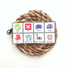 a wicker basket with four matching cards on it that include words and pictures in the same language