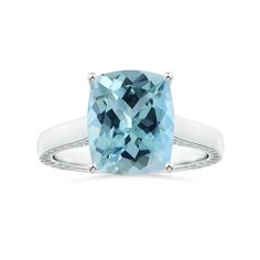 a cushion cut blue topazte ring with diamonds on the shoulders and sides, set in 18k white gold