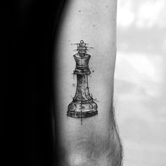 a black and white photo of a chess piece tattoo on the right arm, with lines drawn across it