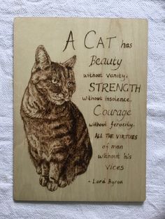 a wooden sign with a cat on it