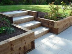 wooden steps leading up to a garden area with grass and trees in the background, text reads give your landscaping a step up