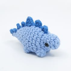 a blue crocheted toy fish with black eyes