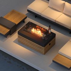 a fire pit sitting on top of a white floor next to couches and tables