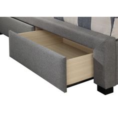 a close up of a couch with an open drawer on the bottom and one side