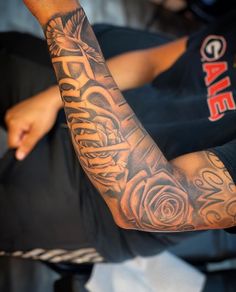 a man with a rose tattoo on his arm