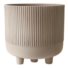 a white planter sitting on top of a wooden stand