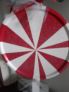 a red and white paper plate sitting on top of a wooden table next to an american flag