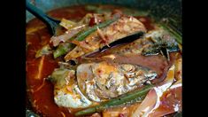 a pan filled with meat and vegetables covered in sauce