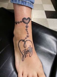 a woman's foot with a tattoo on it that says family and hearts attached to the ankle