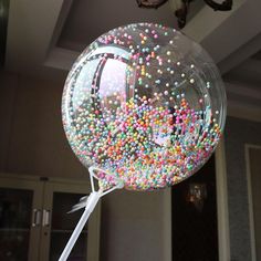 a large bubble filled with lots of sprinkles on top of a table