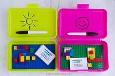 three legos are shown with markers and pencils in their trays on the table