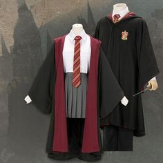 two harry potter costumes on display in front of a wall