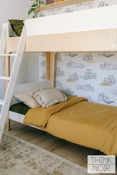 there is a bunk bed with a ladder on the bottom and a pillow under it