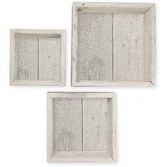 three white wooden frames on a white background