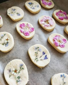 the cookies have been decorated with flowers and are ready to be baked in the oven