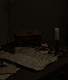 an open book sitting on top of a table next to a candle and other items