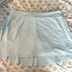 Nike Tennis Skirt Size Xl Never Worn Before Pockets On The Sides Zipper Pocket On The Back Built In Bike Shorts Back Is Slightly Longer Than The Front Small Stain On The Right Side (Picture Included) Measurements: ~ 19 Inches In The Waist L ~ 6 Inch Inseam ~ 16 Inches Top To Bottom In The Front ~ 19 Inches Top To Bottom In The Back Light Blue Stretch Mini Skirt, Light Blue Stretch Skirt, Light Blue Stretch Mini Skort, Light Blue Skirted Bottoms With Elastic Waistband, Nike Stretch Lined Skirt Bottoms, Nike Stretch Short Skort, Nike Lined Skirt For Spring, Nike Casual Pleated Skirt, Blue Tennis Skirt With Short Inseam For Spring