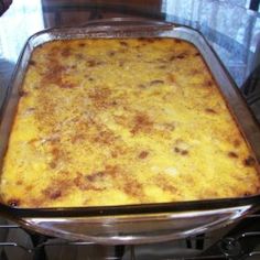 a casserole dish sitting on top of a stove next to a glass counter