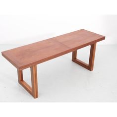 a wooden bench sitting on top of a white floor