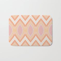 an orange and pink geometric pattern bath mat