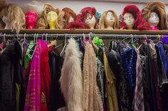 several wigs are lined up on a rack