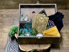 an open wooden box with various items inside