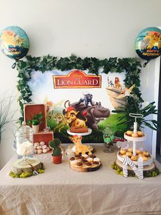 the lion guard dessert table is set up for a birthday party with balloons and decorations